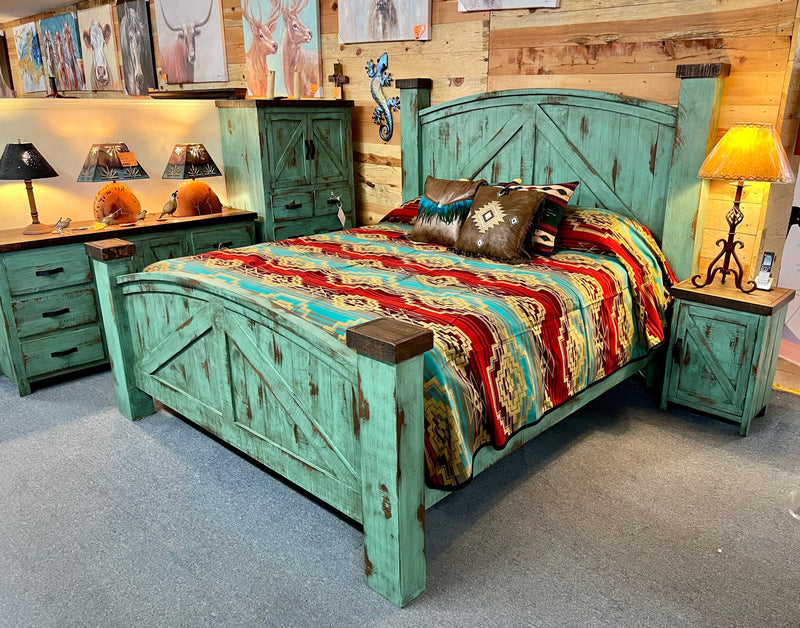 A rustic style bed with a turquoise finish and dark brown accents, featuring a curved headboard and footboard, placed in a room with matching furniture.