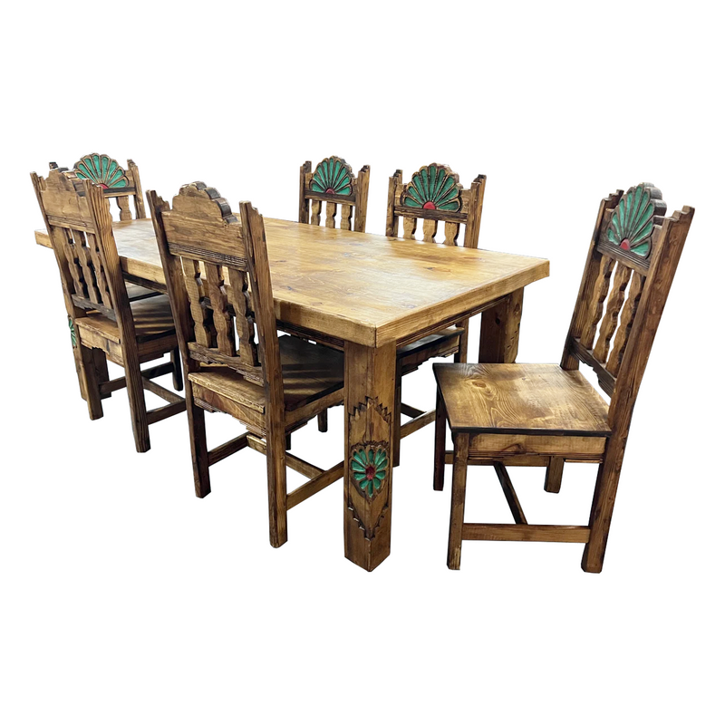 A brown rustic dining set consisting of a rectangular table and six chairs with intricate carvings on the backrest.
