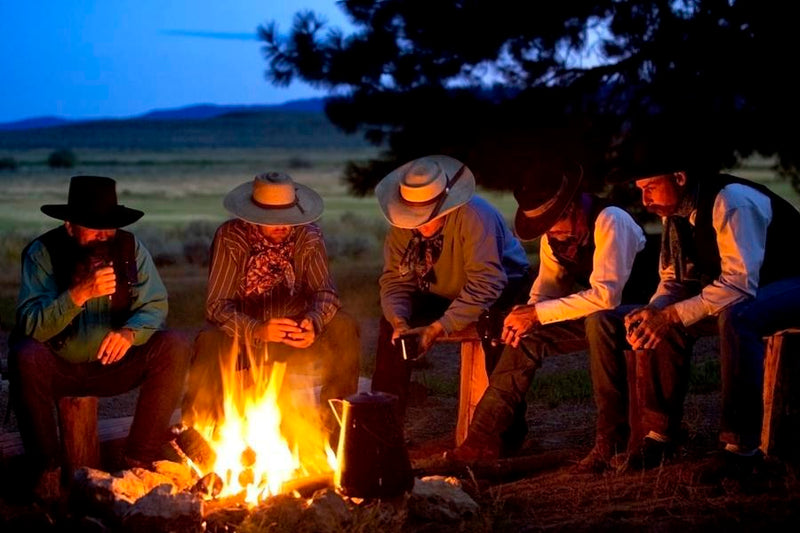 Group Of Cowboys Around A Campfire