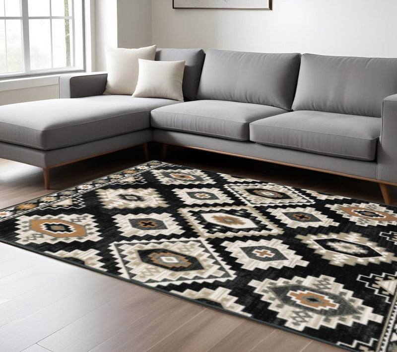 6' X 9' Black Grey Tan Orange And Ivory Southwestern Power Loom Stain Resistant Area Rug