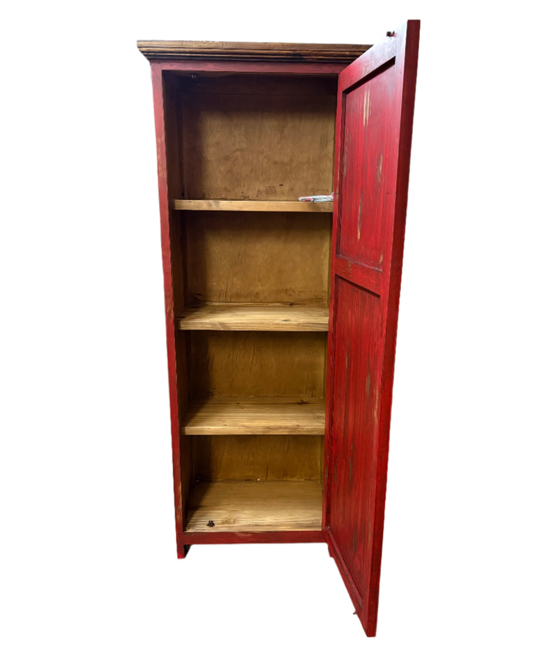Red wooden cabinet with open doors on a gray floor.