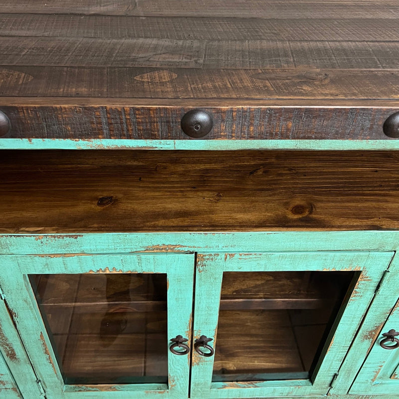Wooden cabinet with turquoise doors against a neutral wall