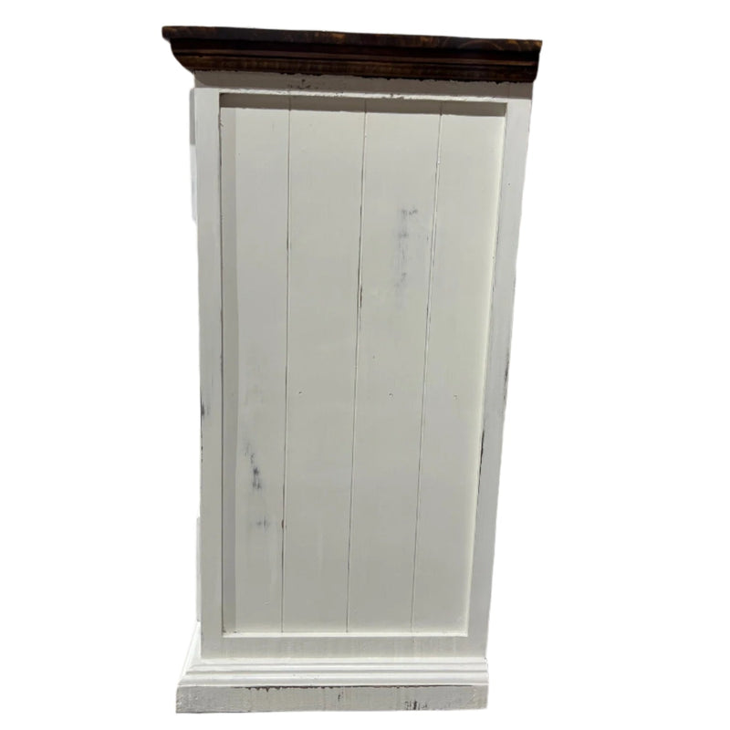 White wooden door on a concrete floor with a metal grid in the background