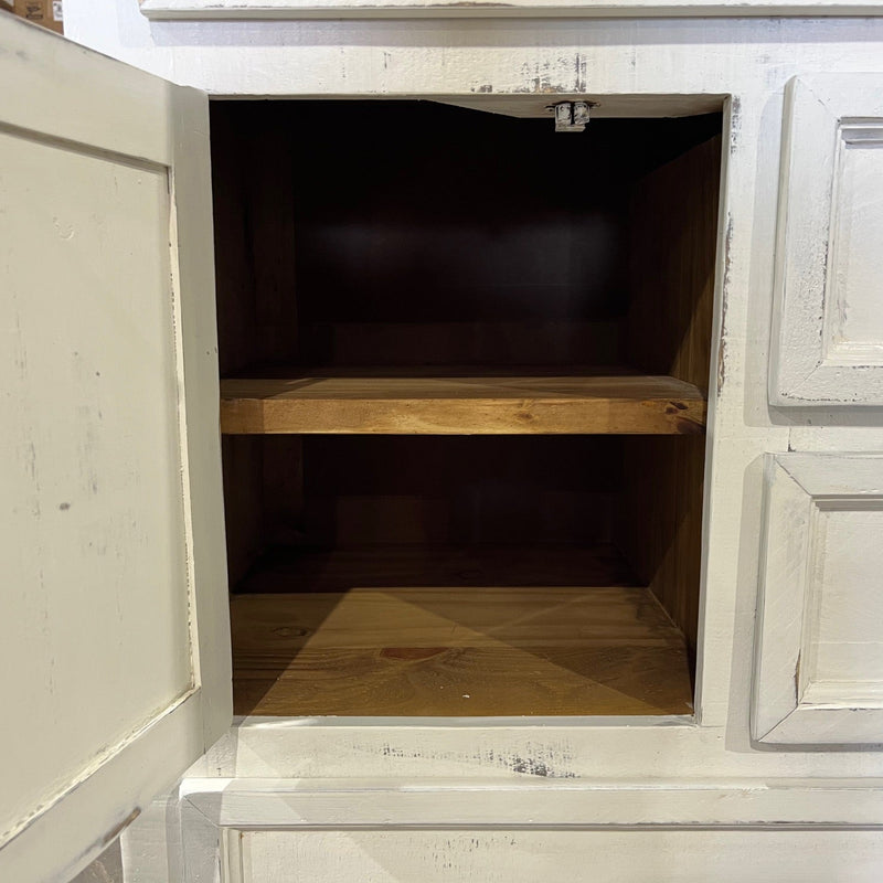 White wooden cabinet with an open door revealing a dark interior.