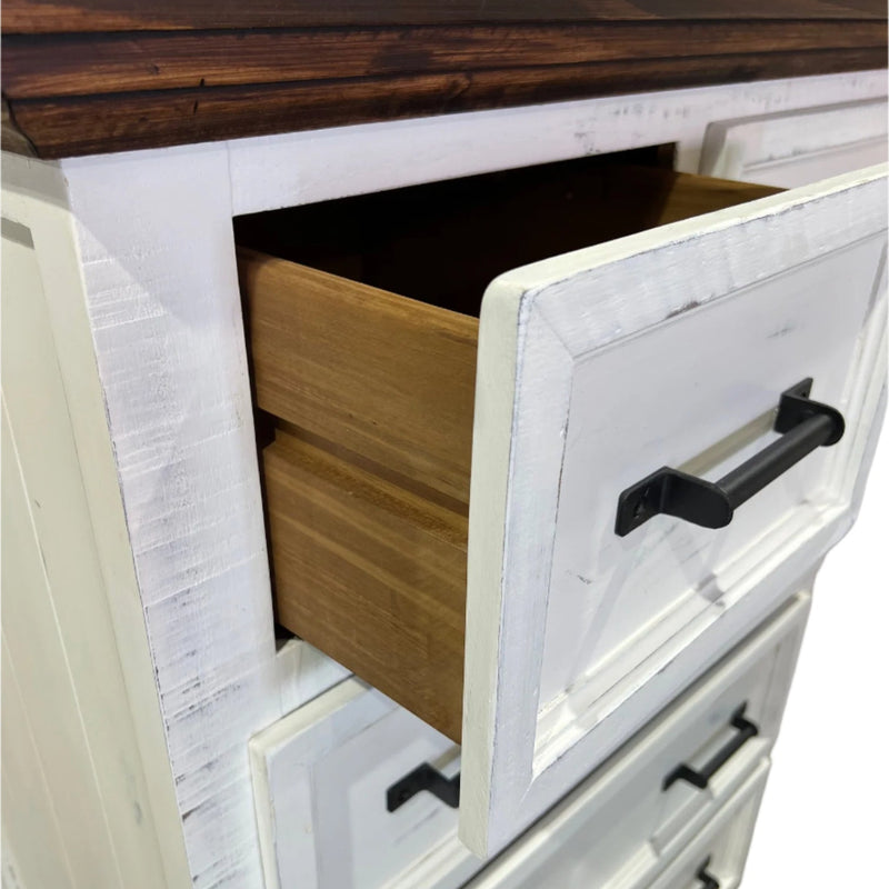 Wooden drawer with white interior and black handles on a wooden cabinet.